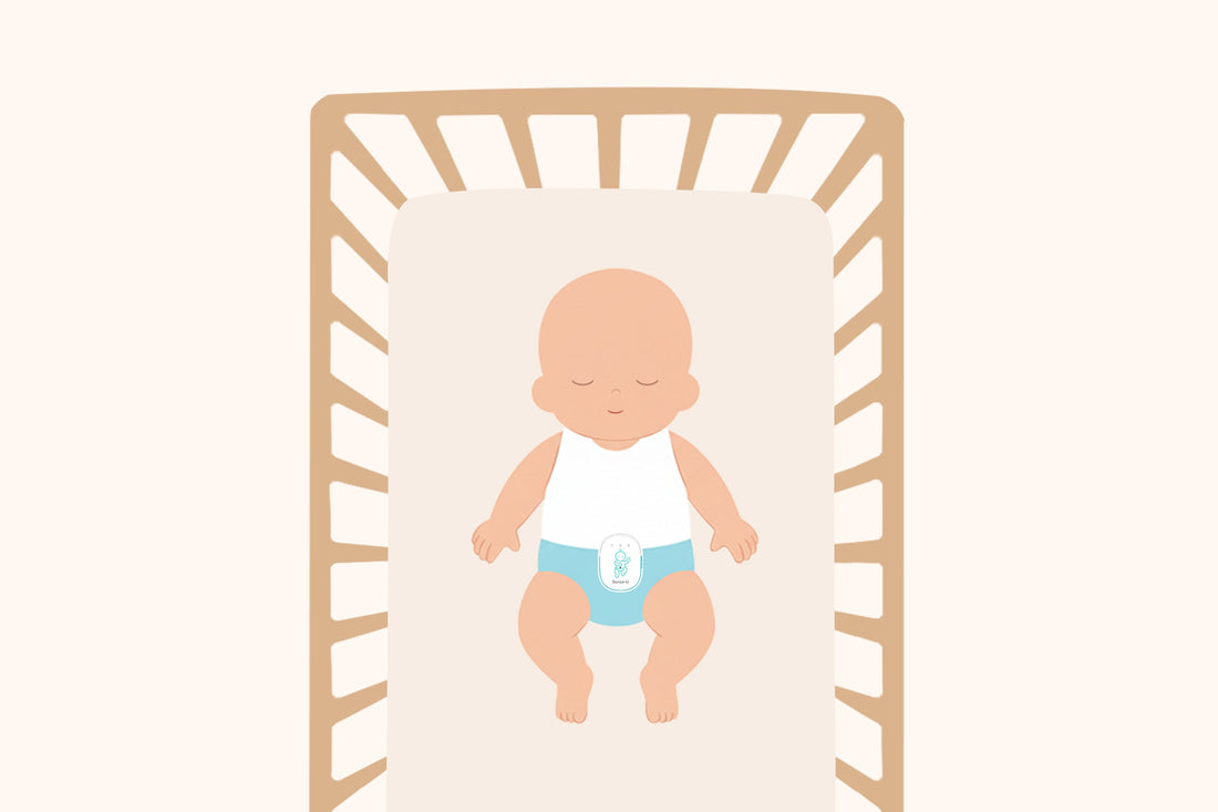 A sleeping baby lying on their back in a crib, wearing a diaper with a Sense-U Pro Baby Monitor clipped to the front, illustrating safe sleep monitoring.